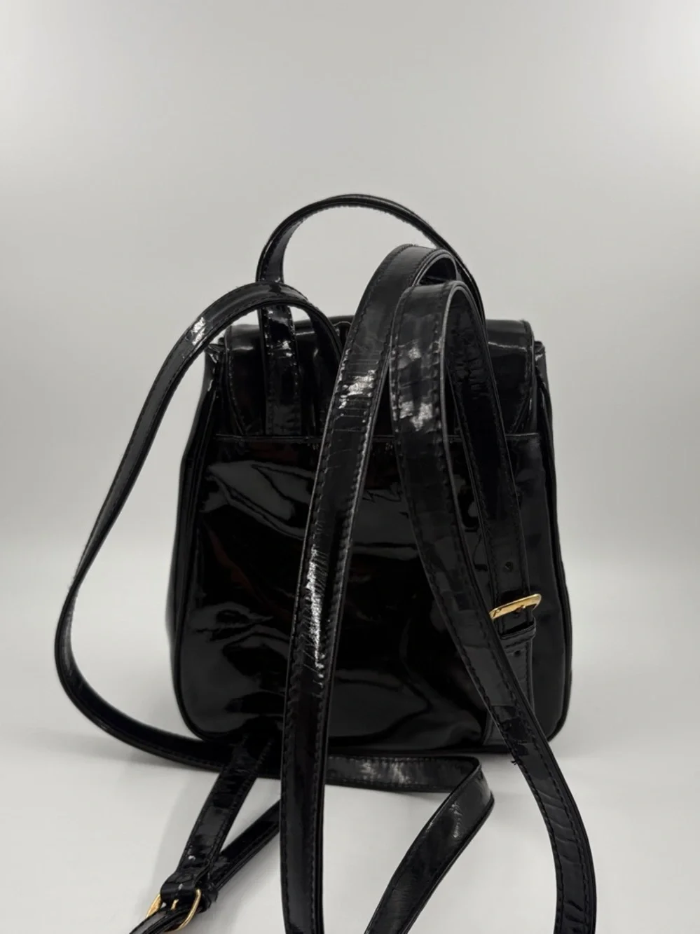 Paloma Picasso Black Patent Mini Backpack with Gold X Hardware